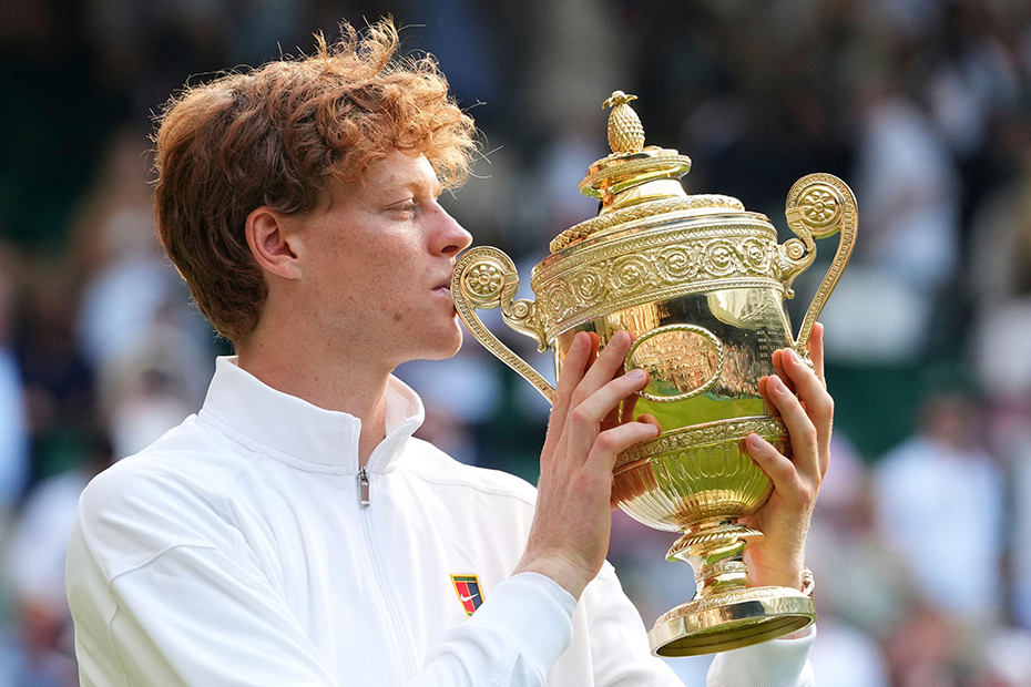 Jannik Sinner of Italy holds the trophy after winning the men's singles final match against Carlos Alcaraz of Spain at the Wimbledon Tennis Championships in London