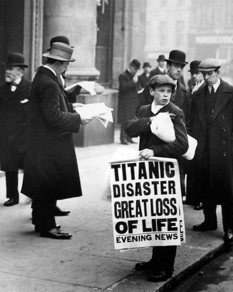 A Newspaper boy selling copies of the London Evening News announcing the sinking of the Titanic, 15 April 1912